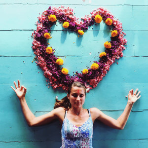 santosha yoga teacher training student lying on flowers