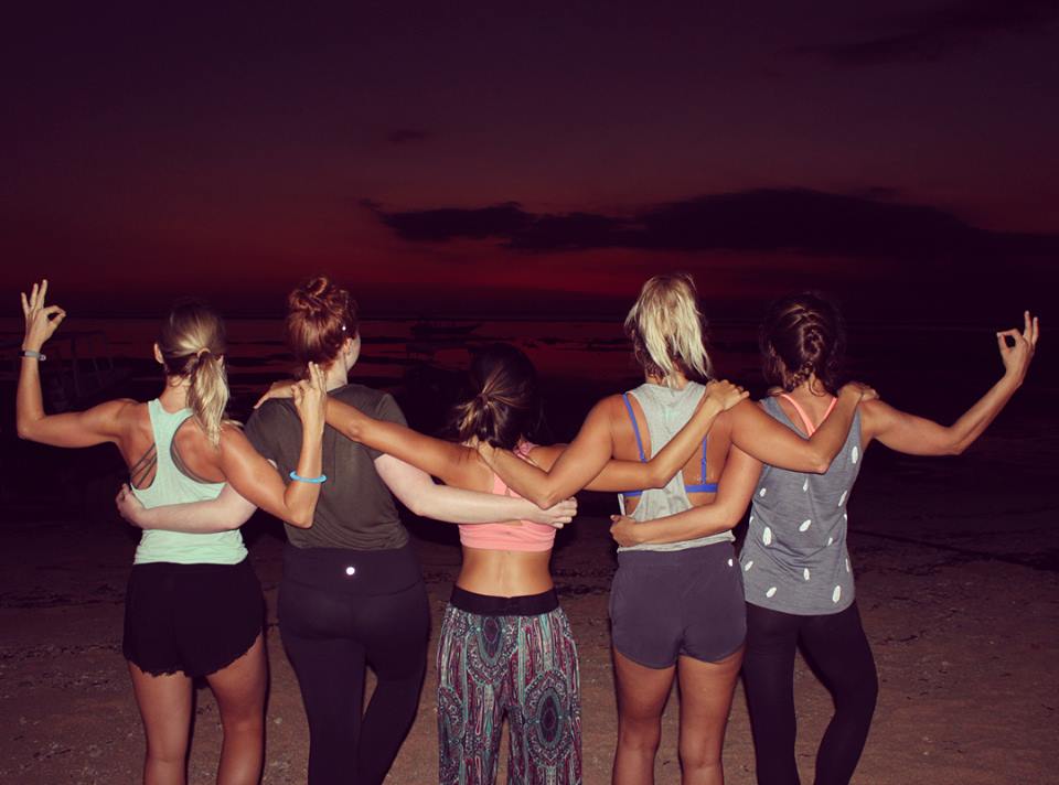 santosha yoga teacher training students on beach sunsetting