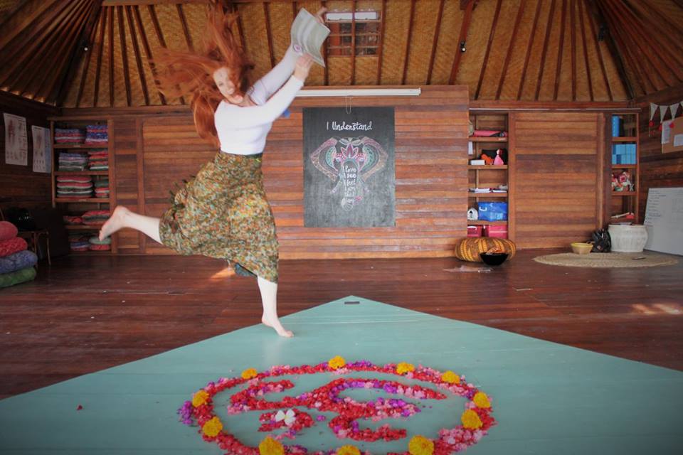 santosha yoga teacher training student jumping with certificate joyfully