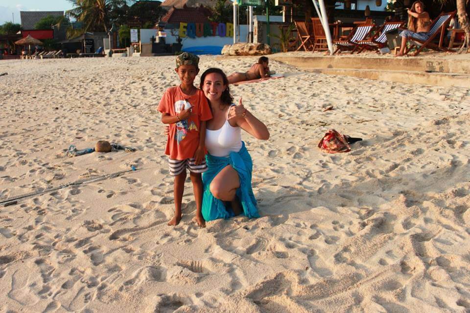 santosha yoga teacher training student on beach with kid